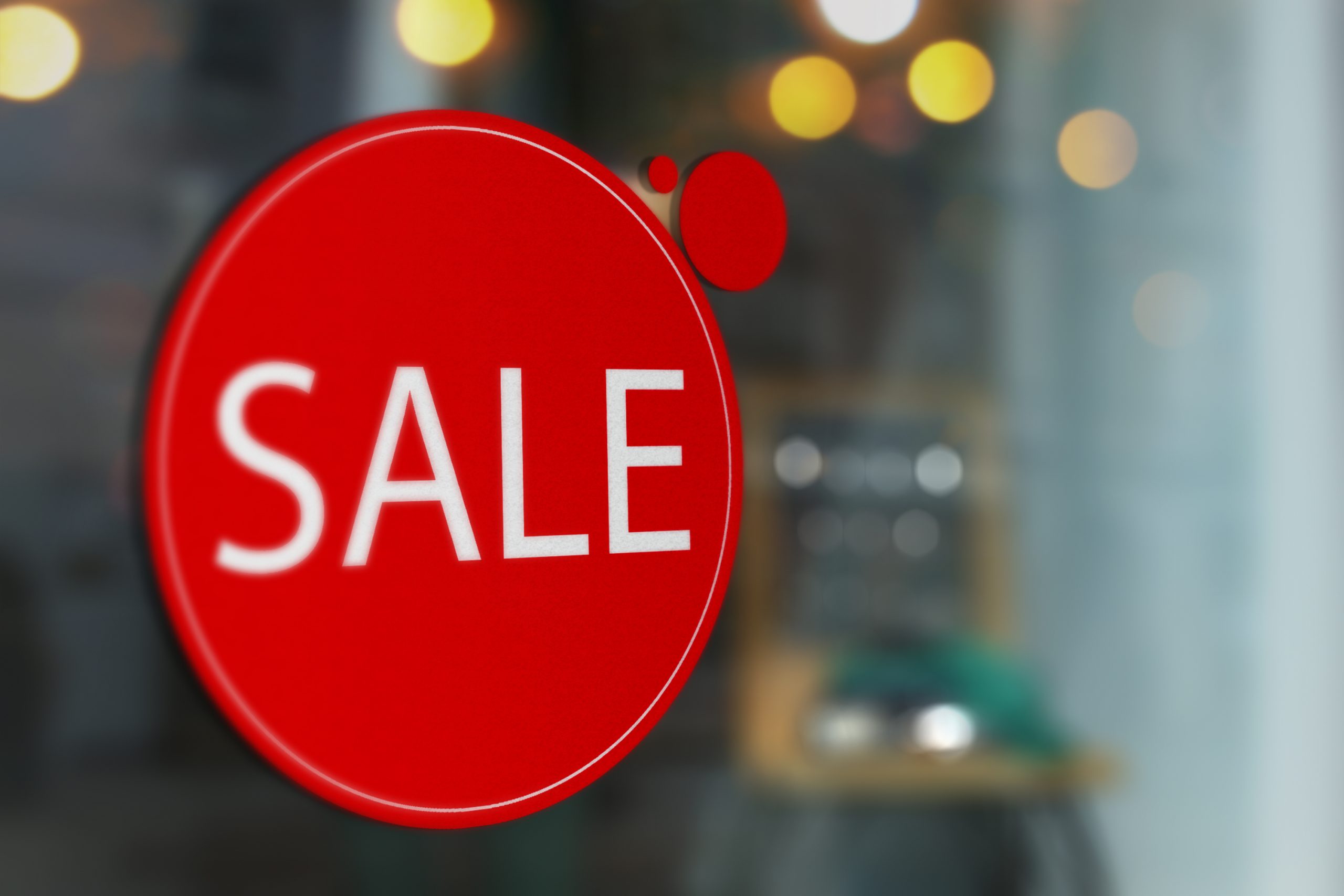 Roter runder SALE-Aufkleber aus Adhäsionsfolie mit weißer Plotterschrift an einer Schaufensterscheibe, ablösbar und wiederverwendbar