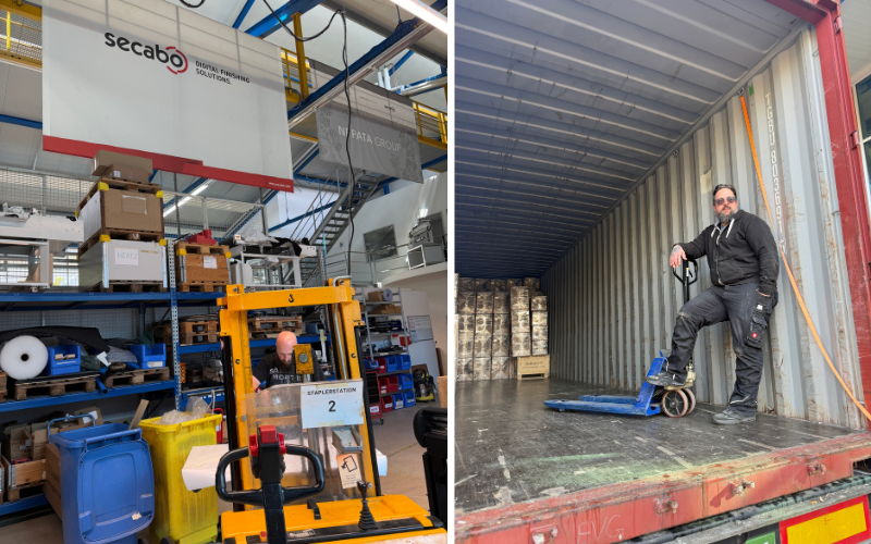 Logistikzentrum: Mitarbeiter am Stapler an Staplerstation 2 im Hochregallager, daneben ein Kollege mit Hubwagen in einem teilbeladenen Container