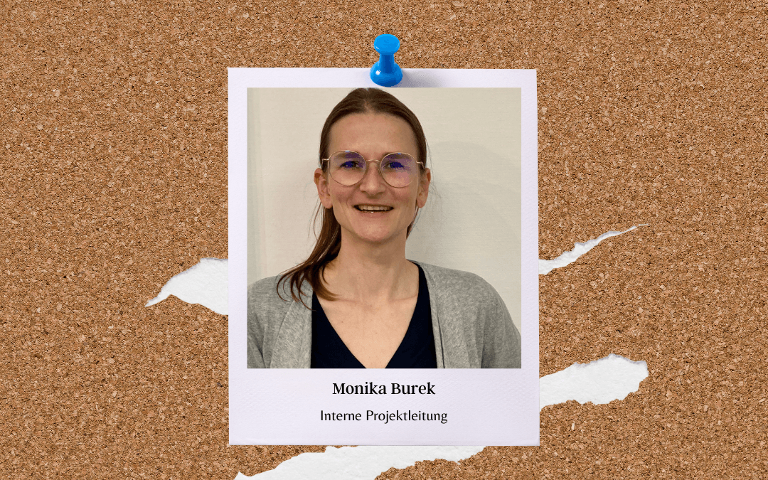 Polaroid on a noticeboard: a smiling Monika Burek wearing glasses and a grey cardigan; caption: Monika Burek, Internal Project Manager