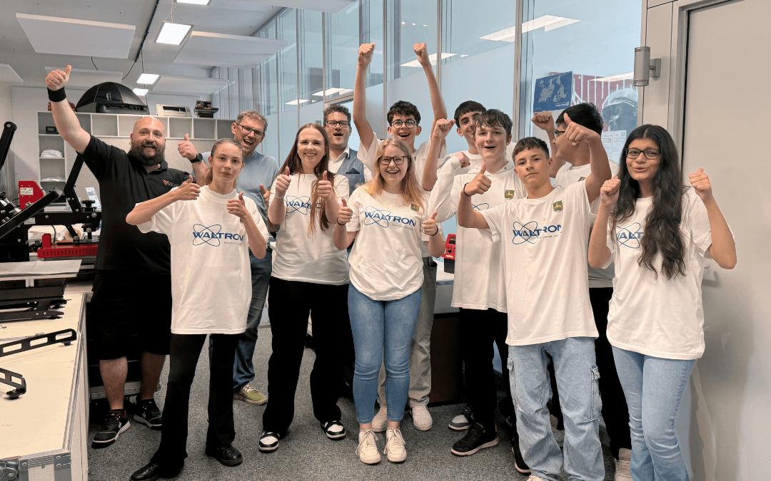 Cheerful Year 8 pupils from Wolnzach Secondary School wearing Waltron T-shirts they had printed themselves, alongside the Nepata team in the YOW! studio, with heat transfer presses next to them