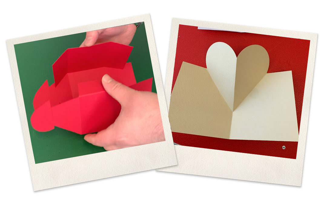 Hände falten rote Schachtel mit Herzlaschen, daneben aufgeklappte beige Karte mit Pop-up-Herz, geschnitten und gerillt mit dem Plotter