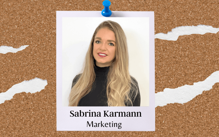 Sabrina Karmann, with long blonde hair, in a Polaroid photo pinned to a cork noticeboard, labelled with her name and ‘Marketing’